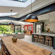 an open kitchen and dining room with skylights above the counter top, is shown in this modern home