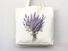 a tote bag hanging on the wall with lavender flowers painted on it's front