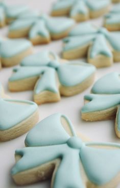 blue decorated cookies are arranged on a table