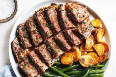 steak, potatoes and green beans on a white plate