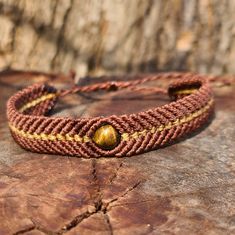 a close up of a bracelet on a rock