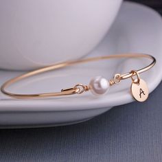 Gold Bangle Bracelet  White Pearl Bracelet by georgiedesigns Elegant Personalized Adjustable Pearl Bracelet, Elegant Personalized Round Pearl Bracelet, Elegant Adjustable Personalized Pearl Bracelet, Elegant Personalized Gift Bracelets, Elegant Round Bracelets For Personalized Gift, Elegant Bangle Name Bracelet For Bridesmaid Gift, Elegant Charm Bracelet For Personalized Gift, Elegant Round Charm Bracelet For Personalized Gift, Classic Rose Gold Pearl Bracelet Gift