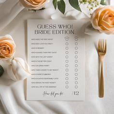 a white table with flowers and a sign that says guess who bride edition