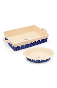 two blue and white dishes with handles on each side, one is holding a dish