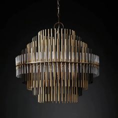 a chandelier made out of wood sticks and glass tubes hanging from the ceiling