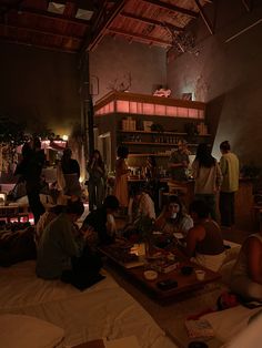 a group of people sitting around a table in a room