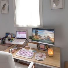 a desk with two laptops and a desktop computer sitting on top of it next to a window