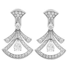 Quintessentially feminine and glamorous, these earrings capture the essence of Italian beauty. Crafted in lustrous 18K white gold. These earrings feature fan shaped motifs studded with pave set round cut diamonds weighing 1.18 carats with two prong set pear shaped diamonds weighing 1.40 carats and two prong set round brilliant cut diamonds weighing 0.30 carat. Total diamond weight: 2.88 carats. Earrings size: 1.2 inches. Secured with hinged closure. Total weight: 14.28 grams. A perfect addition Bulgari Divas Dream, Bvlgari Divas Dream, Bracelets Design, Italian Beauty, Harry Winston, Pear Shaped Diamond, Fine Jewellery Earrings, Round Brilliant Cut Diamond, Round Cut Diamond