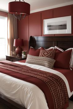 a bed with red and white comforter in a bedroom next to two lamps on either side of the bed