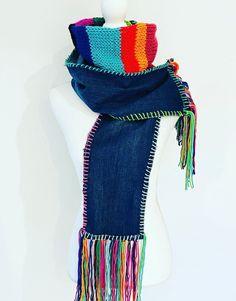 a blue scarf with multicolored fringes on top of a mannequin head