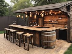 an outdoor bar with stools and lights