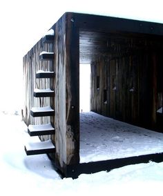 a wooden structure with stairs in the snow