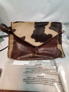 Hobbs London Leather Bag Cow Hide print purse handbag. In excellent shape, shows much better than the pictures show, a darker brown leather. May never have been used at all?? The inside is mint and shows no sign of usage. Only issue is the little discolored dot on photo 11,12, feels and looks to believe a slight defect in the pigmentation, not noticeable at all!! Shipped with care. Brown Cow Print Bag For Everyday Use, Cow Hyde, Leather And Cowhide Purses, Cow Print Handbags, Cow Print Bag, Brown Cow Print Bag, Hobbs London, Cowhide Print, Printed Purse