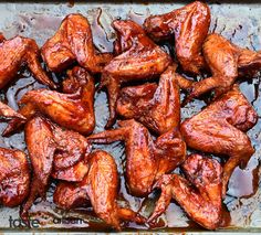 chicken wings are cooked and ready to be served in the oven, with brown sauce on top