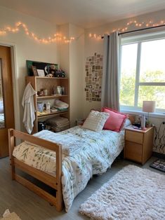 a bed room with a neatly made bed and lots of lights on the windowsill