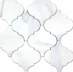 a white marble tile with an intricate design