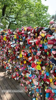 a fence covered in lots of padlocks and heart - shaped locks on it