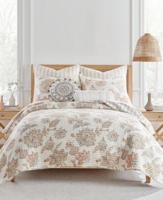 a bed in a bedroom with white walls and wooden headboard on the nightstands