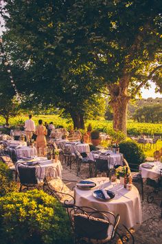 an outdoor dining area with tables and chairs set up for people to enjoy the outdoors