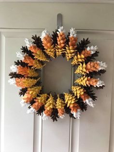 a wreath made out of fake leaves on the front door to decorate it for fall