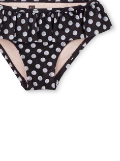 Black-and-white and cute all over, our polka dotted ruffle bikini bottom pairs swimmingly with a Tea tankini or swim top. A fitted poly/spandex blend gives the perfect amount of stretch. Bonus design details: a cozy fully-lined interior, elastic drop waist, and UPF 40+ for sun protection. Playful Black Bottoms For The Beach, Beach Season Ruffled Swimwear, Summer Polka Dot Tankini For Swimming, Black Stretch Swimwear For Play, Polka Dot Tankini For Summer Swimming, Polka Dot Stretch Swimwear, Black Summer Beachwear Swimwear, Poolside Fitted Polka Dot Tankini, Polka Dot Fitted Tankini For Poolside