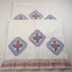 two pieces of cloth with pink roses on them