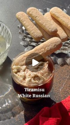 some bread sticks sitting on top of a table next to a bowl of dip and sauce