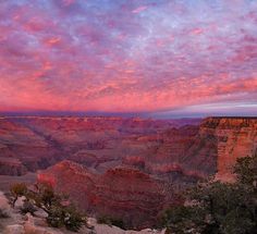 the sky is pink and purple as it sets over the grand canyon in arizona, usa