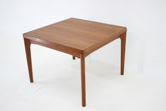 a small wooden table sitting on top of a white floor