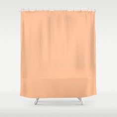 an orange shower curtain hanging on a white wall