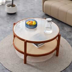 a coffee table with a bowl of fruit on it