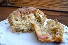 a half eaten muffin sitting on top of a white plate