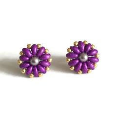 Cute And Colorful Flower Stud Earrings Made With Beautiful Deep Purple Glass Twin Beads. The Flowers Are Accented With Lavender Swarovski Crystal Pearls And Gold Seed Beads. Handmade With Super Strong Beading Thread. Not Intended For Children Under 12. Purple Flower Shaped Beaded Earrings For Gifts, Beaded Studs, Black Pearl Earrings, Twin Beads, Beading Thread, Flower Stud Earrings, Heart Dangle Earrings, Flower Stud, Beads Handmade