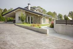 a house with a large driveway in front of it