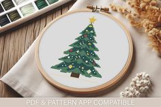 a cross stitch christmas tree on a table