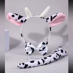 the dalmatian headband is decorated with white and black spots on it's ears