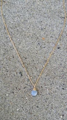 "A simple tiny blue opal stone suspended from a delicate gold filled or sterling silver chain. Perfect for adding a touch of color to any layered ensemble. The stone is a tiny 7mm and a beautiful opaque periwinkle blue color. It matches everything! Shown here in 16\" length. *If you are unsure of the length you need, or would like to wear this item at different lengths, we now offer an adjustable length option! You can add an adjustable end to your necklace using this link: https://www.etsy.com/ Dainty Blue Moonstone Jewelry, Everyday Gold Opal Jewelry, Blue Moonstone Teardrop Necklace, Dainty Blue Charm Necklace For Everyday, Blue Dainty 14k Gold-filled Jewelry, Gold Chalcedony Jewelry As A Gift, Dainty Blue 14k Gold-filled Jewelry, Minimalist Wire Wrapped Blue Jewelry, Minimalist Blue Teardrop Pendant Jewelry