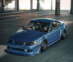 a blue car parked in an empty parking lot