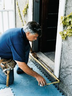 a man is painting the outside of a house