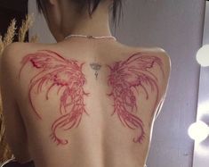 the back of a woman's body with tattoos on her upper and lower back