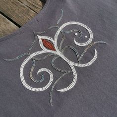 an embroidered design on the back of a shirt