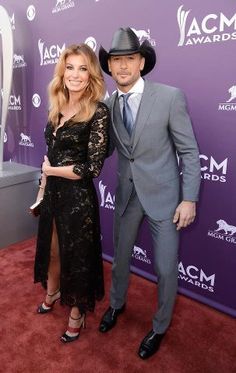 a man and woman posing on the red carpet at an awards event for country music