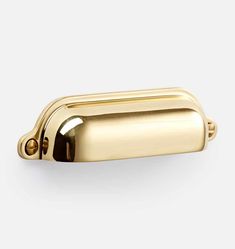 a gold door handle on a white background