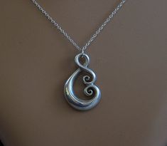 Hand crafted New Zealand Maori koru design in solid 925 Sterling silver. With a high polish finish. A lovely sculptural piece fully shaped on the front and the back. Made here in the South Island of New Zealand by my partner & I. The two koru meeting together show a symbol of love and growing together with eternal bonding and open hearts. The koru is a treasured symbol in NZ..it is found in nature and symbolises renewal & spiritual growth. Hallmark stamped .925 Measures 1.1 inches or 3cm Maori Koru, Growing Together, Love Symbol, Ethnic Necklaces, My Partner, South Island, Metal Clay, Love Symbols, Spiritual Growth