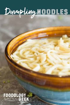 a close up of a bowl of food with noodles in it and text overlay that reads dumpling noodle soup