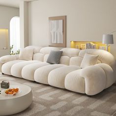 a large white couch sitting in a living room on top of a carpeted floor