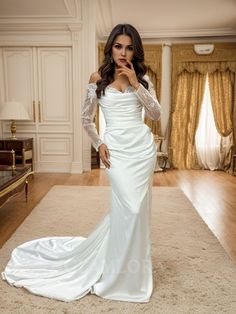 a woman in a white wedding dress posing for the camera