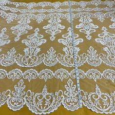 Introducing our exquisite Beaded and Corded Bridal Lace Fabric, a true masterpiece from Lace USA. This stunning fabric is crafted with meticulous attention to detail, making it the perfect choice for any special occasion. Made from 100% polyester net mesh, this luxurious lace fabric is delicately embroidered with an array of stunning beads and cords. The intricate design adds a touch of regal elegance, making it a show-stopper at any dance, wedding, or costume event. Whether you're a couture des Cream Embroidered Lace For Ceremony, White Embroidered Fabric For Ceremonies, White Embroidered Lace For Ceremony, Elegant Embroidered White Lace, Traditional White Lace For Wedding, White Embroidered Fabric For Ceremony, Ceremony Embroidered Cream Lace, White Intricate Embroidered Fabric For Ceremony, White Lace With Intricate Embroidery For Ceremonies