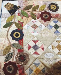 a close up of a quilt with flowers on it