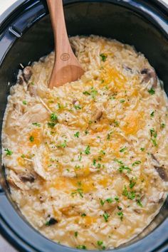 a crock pot filled with mashed potatoes and mushrooms